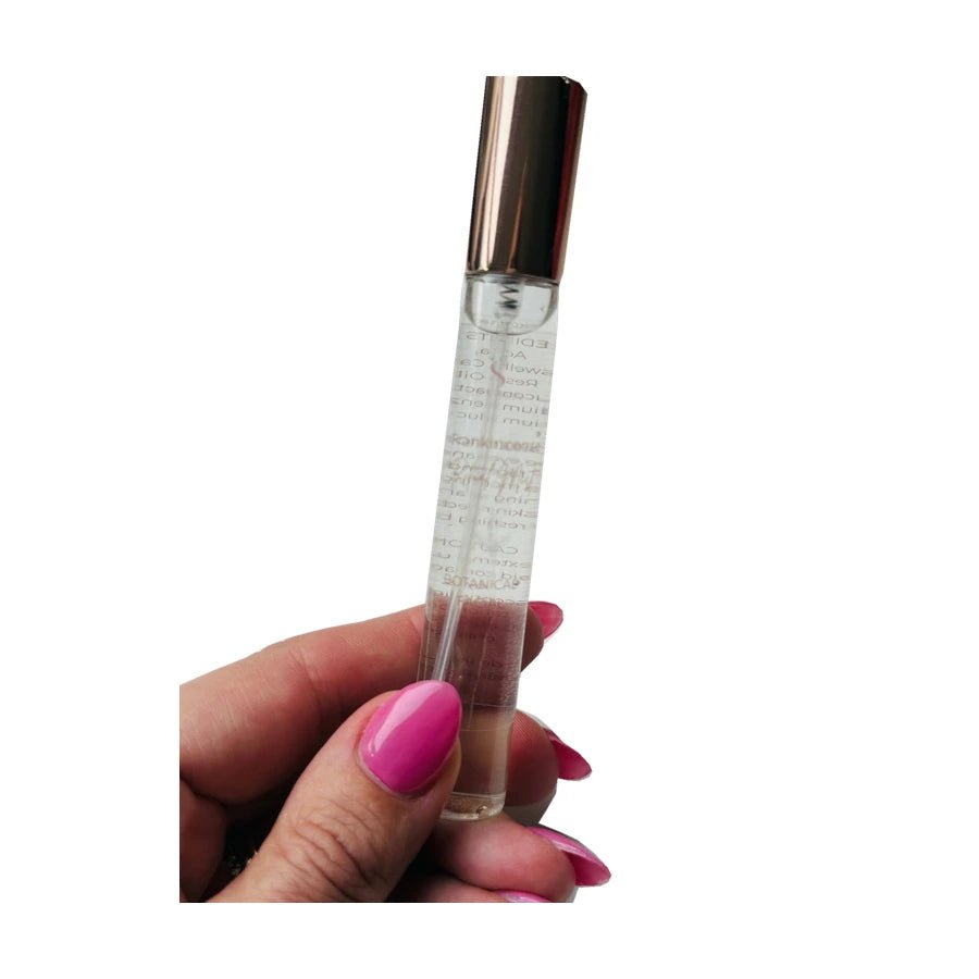 Sacred Frankincense Mist held in a hand on white